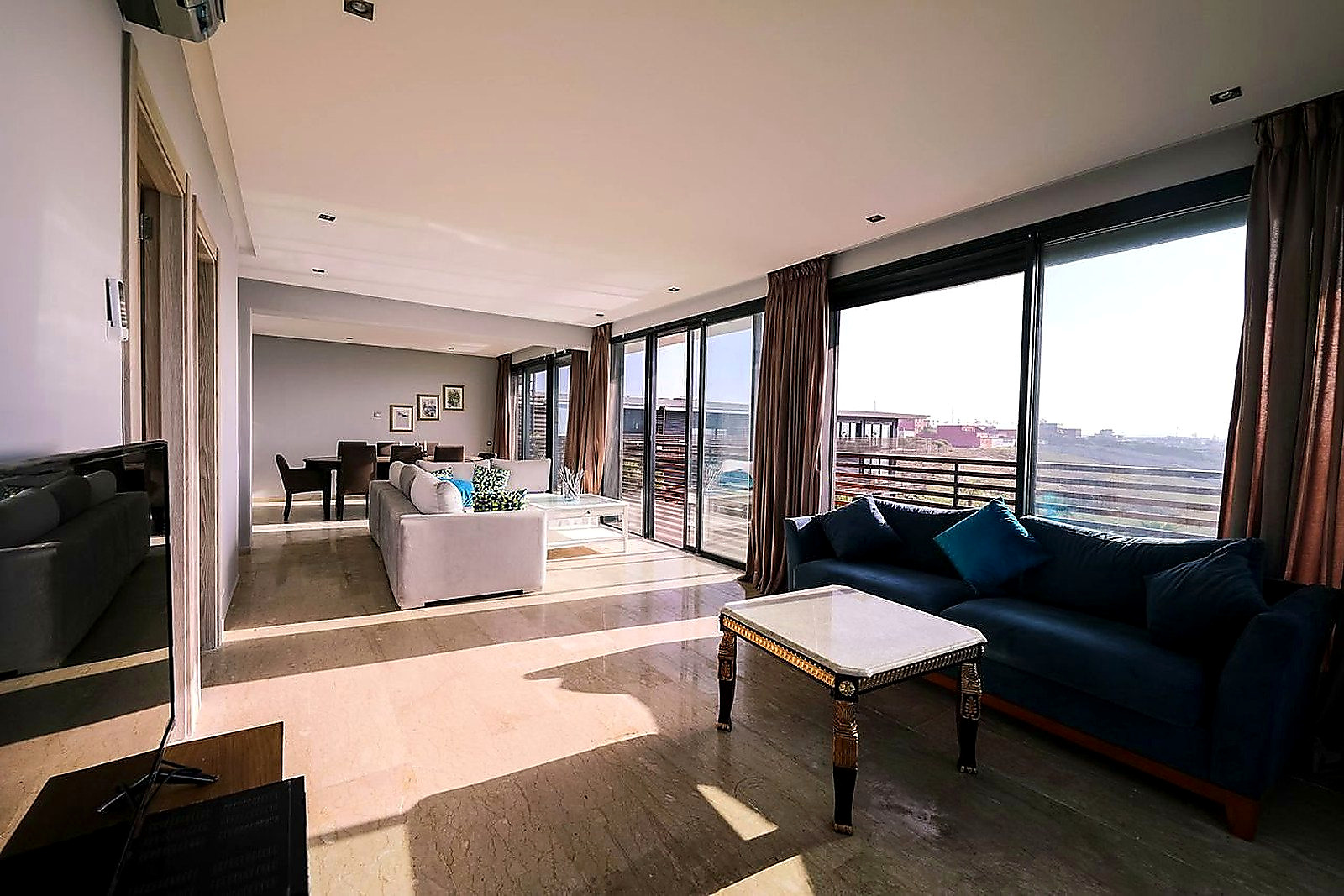 Free Bright and airy contemporary living room with furniture and large windows overlooking a city view. Stock Photo